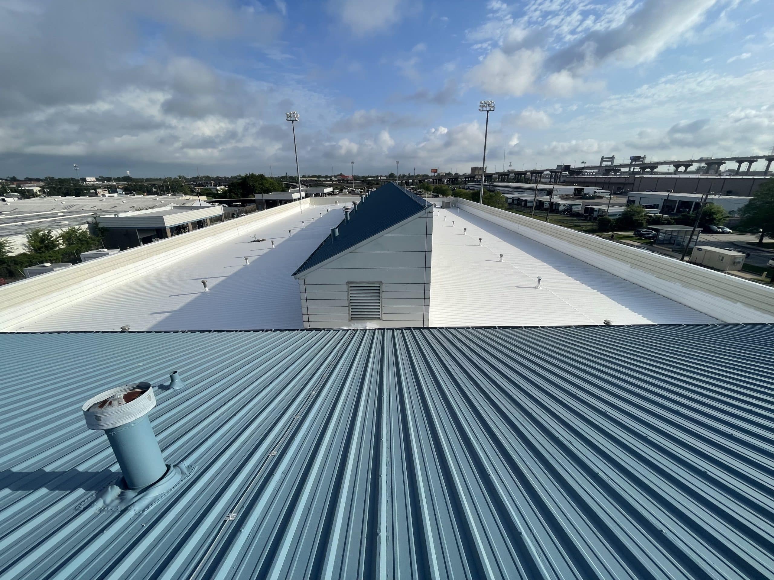 The roof of a building with a blue metal roof.