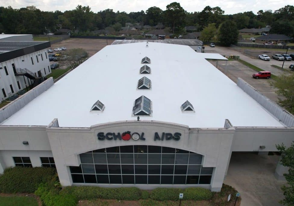 An aerial view of a building with a white roof.